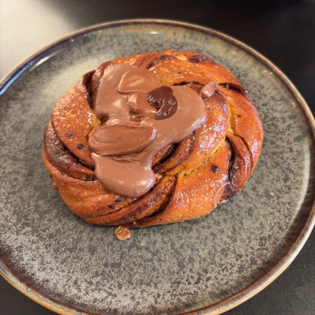 Freshly baked chocolate-hazelnut croissants on a stone plate at Bkry, an industrial-chic bakery in Alserkal Avenue, Dubai.
