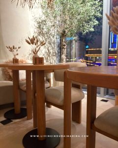 Ground floor coffee shop and reception area at Samsara Yoga Dubai Marina with minimalist design.