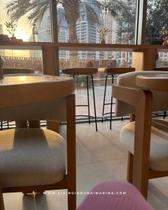 Ground floor coffee shop and reception area at Samsara Yoga Dubai Marina with minimalist design.